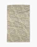 The Shell Whisper tea towel by Geometry features a beige Geoweave™ fabric with an abstract, fan-shaped pattern in lighter tones evenly spread across the surface.