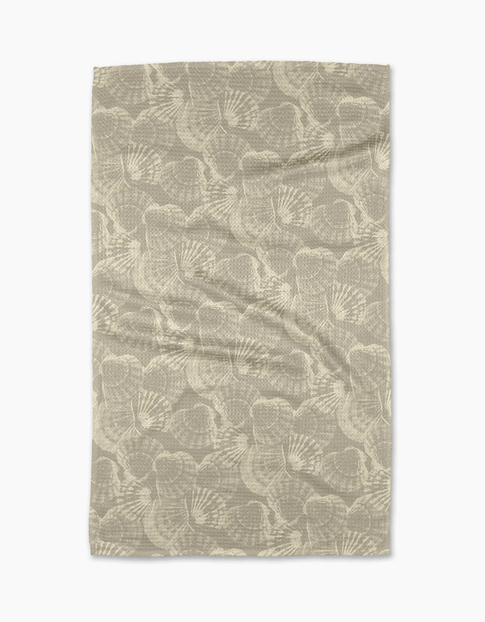 The Shell Whisper tea towel by Geometry features a beige Geoweave™ fabric with an abstract, fan-shaped pattern in lighter tones evenly spread across the surface.