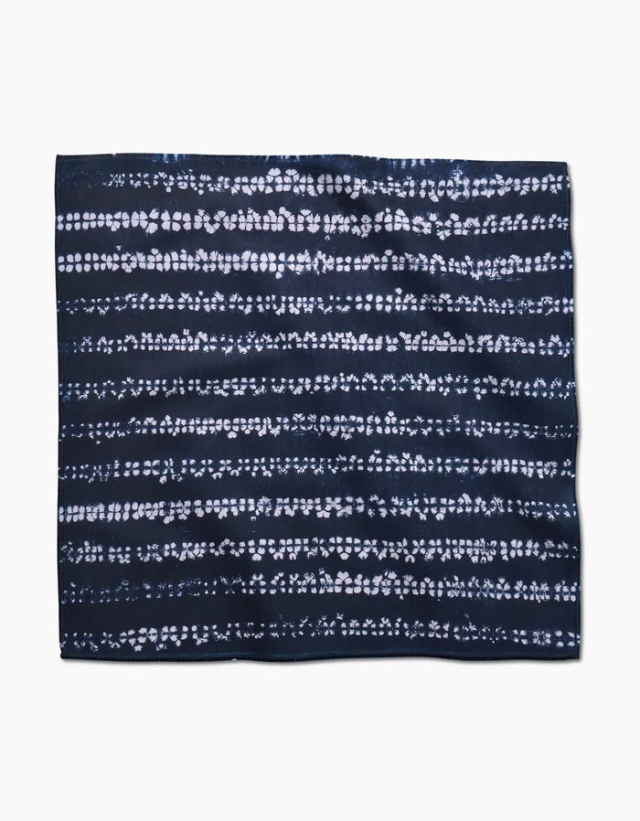 The Shibo by GEOMETRY features a rectangular dark navy blue Geosuede fabric with horizontal white dotted and dashed patterns, evoking a tie-dye or shibori design, shown on a plain white background.