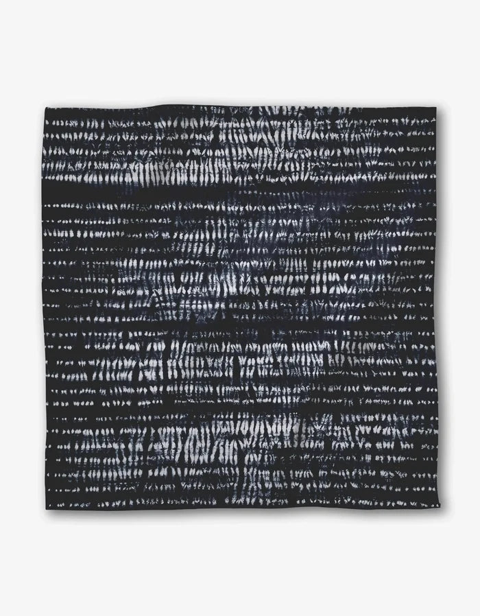 Shibo by GEOMETRY features a square black Geosuede fabric accented with irregular horizontal white lines and dashes, creating an abstract, textured pattern on its surface.