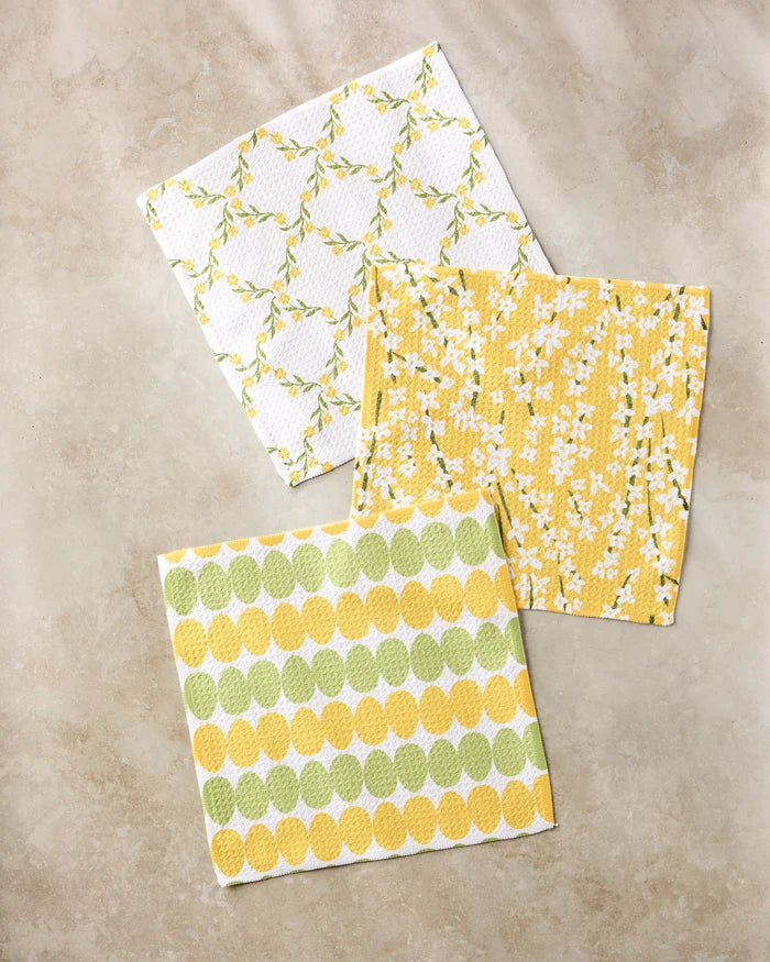 Kayla Ann’s Signs of Springtime features three square paper napkins with floral and leaf patterns in yellow, green, and white—an eco-friendly accent that pairs perfectly with a recycled dishcloth set.