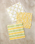 Kayla Ann’s Signs of Springtime features three square paper napkins with floral and leaf patterns in yellow, green, and white—an eco-friendly accent that pairs perfectly with a recycled dishcloth set.