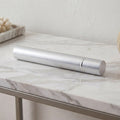 Silver scattering tube on a marble surface