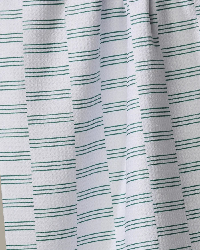 A close-up of The Buy Guide’s Small Stripe - Evergreen kitchen towel, showing its white textured fabric with thin green stripes—an eco-friendly choice for everyday use.