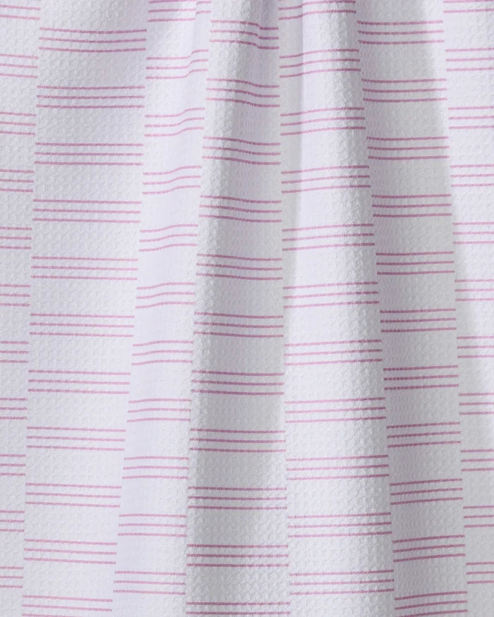 A close-up of The Buy Guide’s Small Stripe - Pink towel shows white textured fabric with evenly spaced pink stripes, a draped look, and subtle shadows highlighting the ultra-absorbent material.