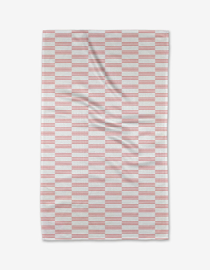 The Buy Guides Small Stripe - Red tea towel features evenly spaced horizontal red and blue stripes on white Geoweave fabric, shown flat with slight creases.