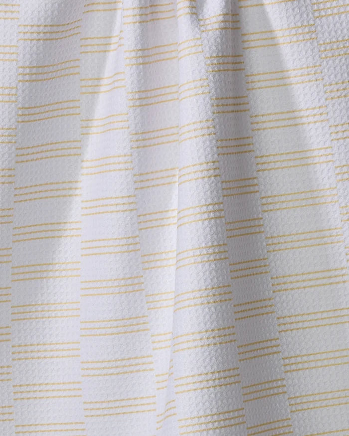 The Buy Guide's "Small Stripe - Yellow" tea towel features white textured fabric with thin yellow stripes, made from recycled materials. Ultra-absorbent and soft, it brings subtle elegance and sustainability to your kitchen.