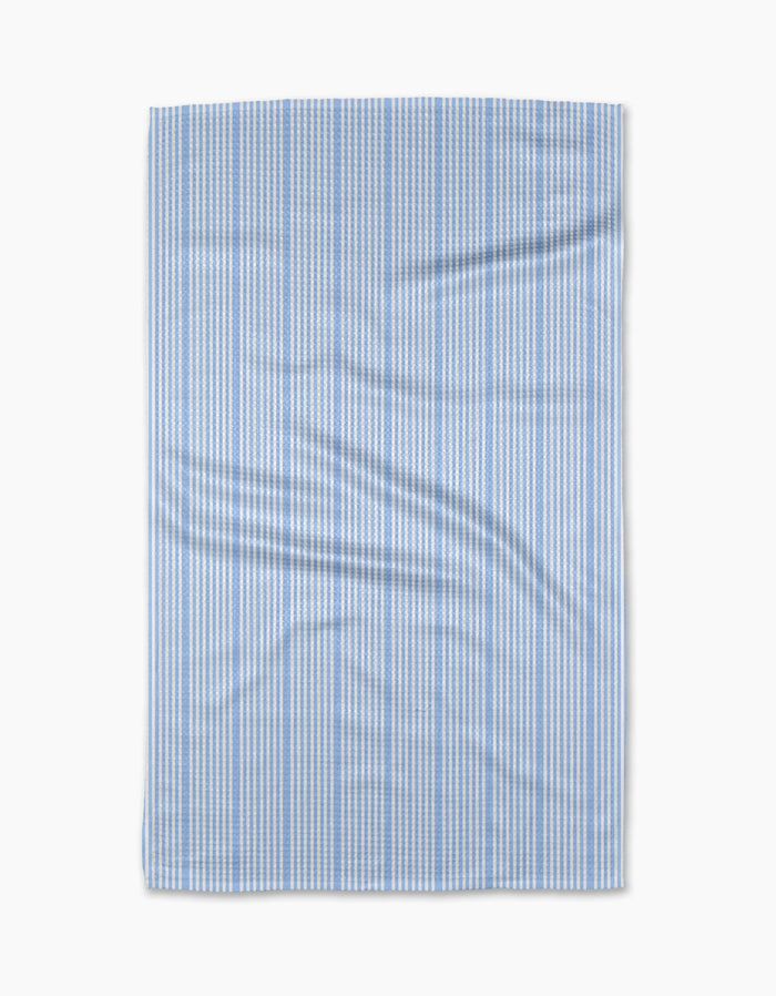 The Geometry “Soft Summer Blue” tea towel features thin vertical blue and white stripes on ultra-absorbent Geoweave fabric, displayed flat with subtle creases against a plain white background.