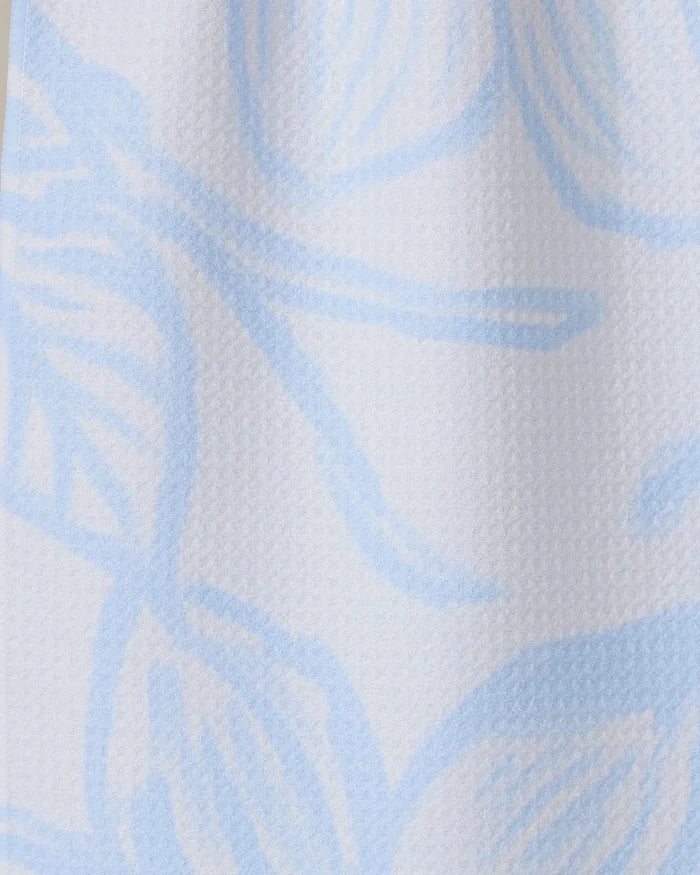 Close-up of GEOMETRY’s Something Blue, featuring textured white Geoweave fabric with a soft surface and a light blue abstract floral pattern of large, flowing lines and petal-like shapes.