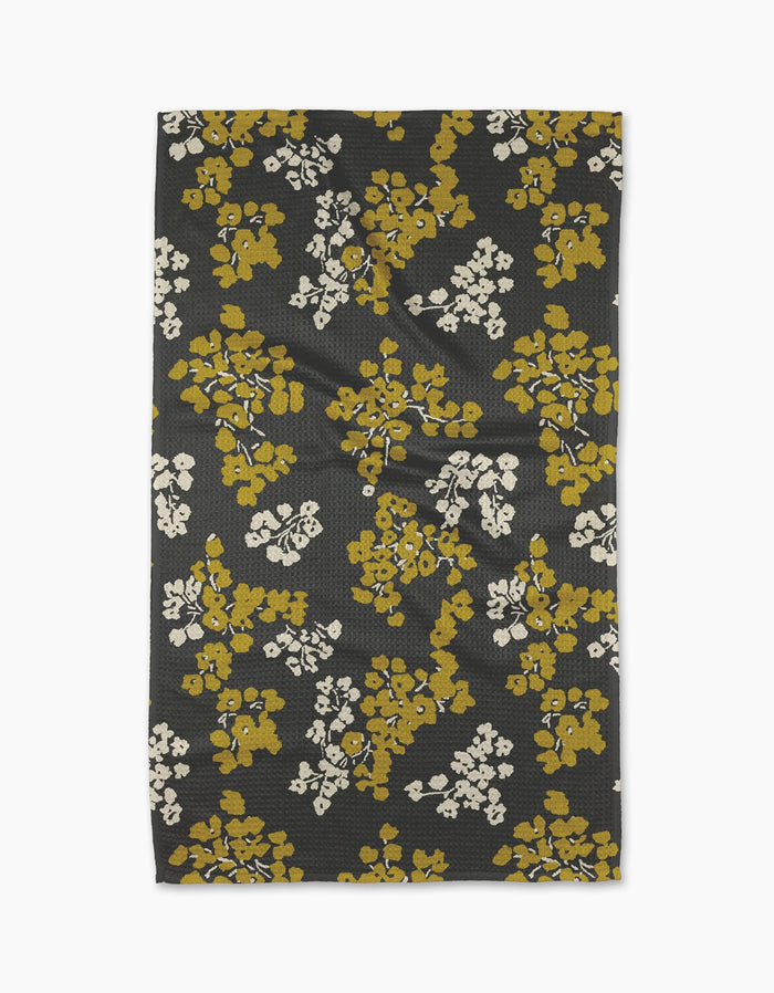 Geometry’s Sonnet Ember tea towel features a black background with mustard yellow and white floral clusters. Made from recycled materials, it’s a stylish and eco-friendly choice for your kitchen.