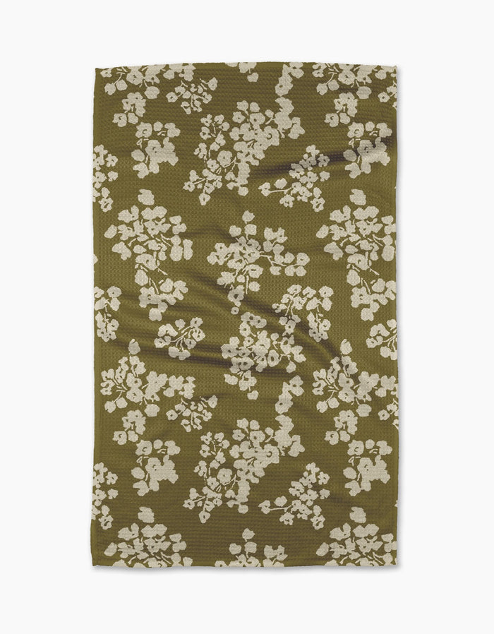 The Geometry Sonnet Olive recycled kitchen towel features a textured olive green surface with irregular white floral clusters, shown flat against a white background.
