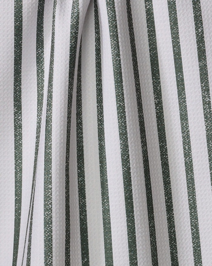 Close-up of the Becki Owens Spearmint tea towel, featuring textured white fabric with vertical green stripes. The slightly folded material creates soft curves and subtle shadows along the striped pattern.
