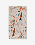 The Spirit of the Ocean Luxe Bath Towel by Janna Sue Design features diverse women swimming with sea life in blue, orange, and peach on a light background. Made with ultra-absorbent recycled materials for style and sustainability.