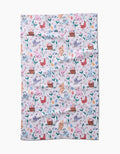 The Spring Bunnies tea towel by Charlie Rowan Designs features a colorful pastel pattern of chickens, eggs, flowers, leaves, and baskets on white. Made from ultra-absorbent recycled materials for style and sustainability.