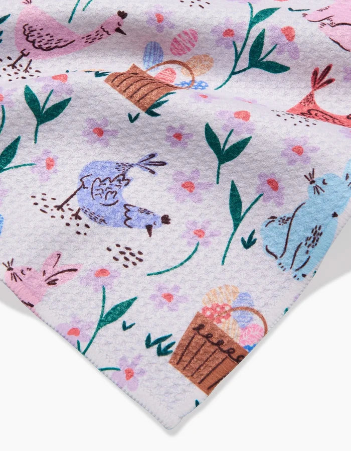 The Spring Bunnies towel by Charlie Rowan Designs features pastel patterns with chickens, bunnies, Easter egg baskets, and green leafy plants on a light background. Ultra-absorbent and perfect for springtime celebrations.