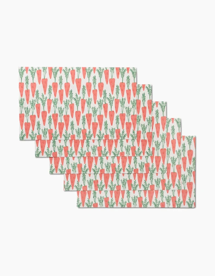 Five rectangular Spring Carrot Hill placemats by Hufton Studio, each with a repeating pattern of orange carrots on white, are perfect to pair with reusable paper towels for an eco-friendly table setting.