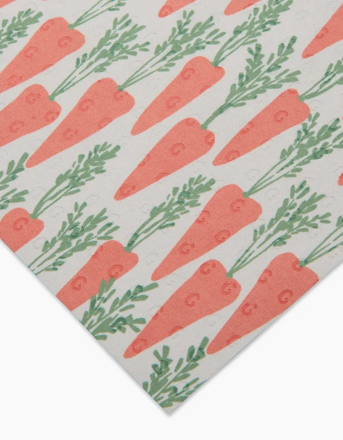 Spring Carrot Hill by Hufton Studio features eco-friendly paper towels decorated with diagonal rows of illustrated orange carrots with green tops on a white background.