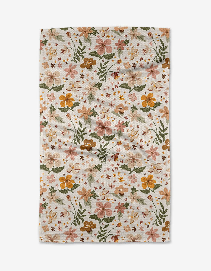 The Danelys Sidron Spring In Devon is a rectangular white cloth of ultra-absorbent Geoweave fabric, decorated with a colorful floral pattern in orange, yellow, pink, and green flowers and leaves.