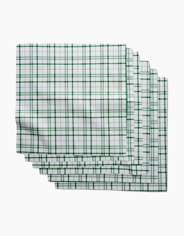 Five Spring Picnic Plaid kitchen towels by Hufton Studio, featuring a green checkered pattern on white and made from post-consumer recycled materials, are stacked with slight overlap on a white background.