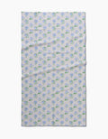 The Spring Wave blanket by Danelys Sidron features a symmetrical blue and green floral pattern on a pale background, made from post-consumer recycled materials.