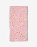 The Blissful Flamingo Springtime Wonders bar towel features a rectangular pink design with yellow and orange teardrop patterns and white swirling branches, made from Geoweave fabric, shown on a plain white background.