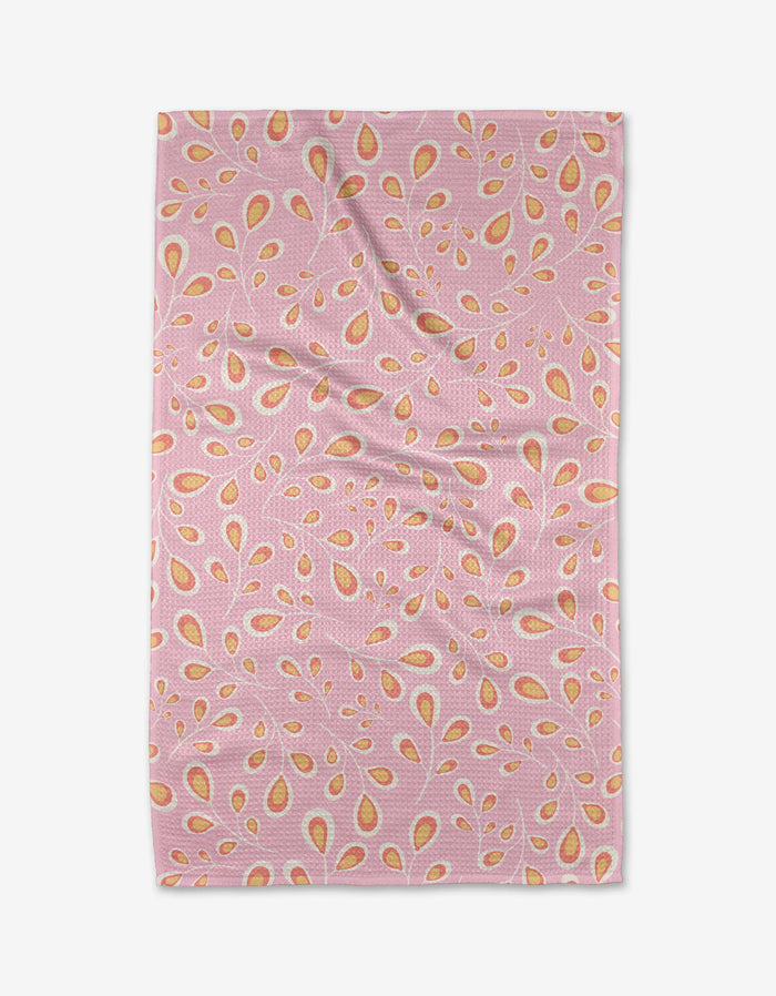 The Blissful Flamingo Springtime Wonders tea towel is pink and rectangular, with yellow and orange teardrop shapes and small leaves on soft Geoweave fabric, shown laid flat with gentle wrinkles.