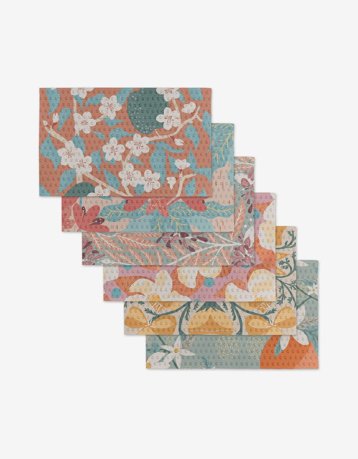 Six rectangular, reusable State Flowers cloth napkins by Julianne Haness, featuring colorful floral and botanical designs in orange, blue, pink, and green—an eco-friendly alternative to paper towels.