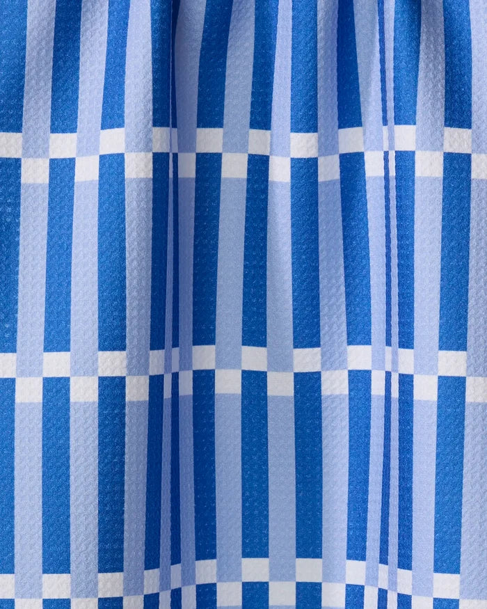 Stripe Block - Blues by The Buy Guide features blue and white checkered fabric with vertical and horizontal stripes in a grid pattern, a subtly textured finish, and soft folds gathered at the top.