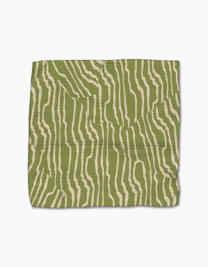 The Geometry Stripe Funk Grounds Green dishcloth features irregular beige wavy stripes on green, made from recycled materials and displayed flat on a white background.
