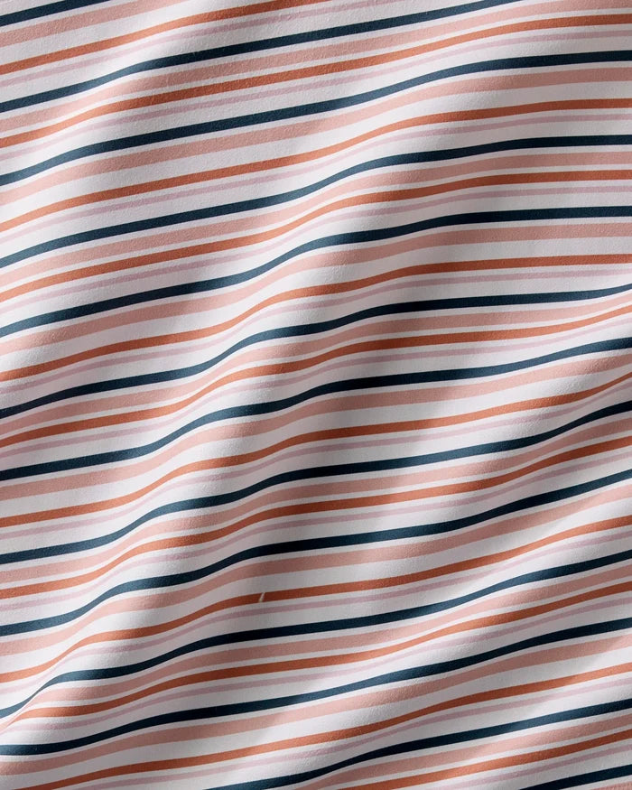 A close-up of Charlie Rowan Designs' Striped Harvest washable cloth napkins featuring pink, navy blue, and white horizontal stripes with a gently wrinkled texture.
