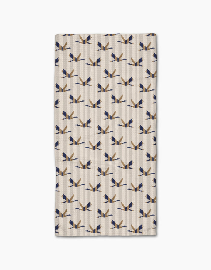The Geometry Striped Nautical Birds Bar Towel is beige with a symmetrical pattern of abstract blue and tan birds on Geoweave fabric, offering superior absorbency and durability.