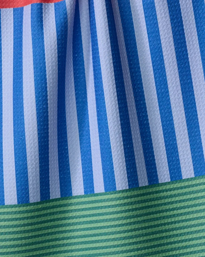 Close-up of The Buy Guide’s Stripes on Stripes dish towel, featuring absorbent fabric with blue and white vertical stripes, a green striped band along the bottom, and a subtle touch of red at the top.