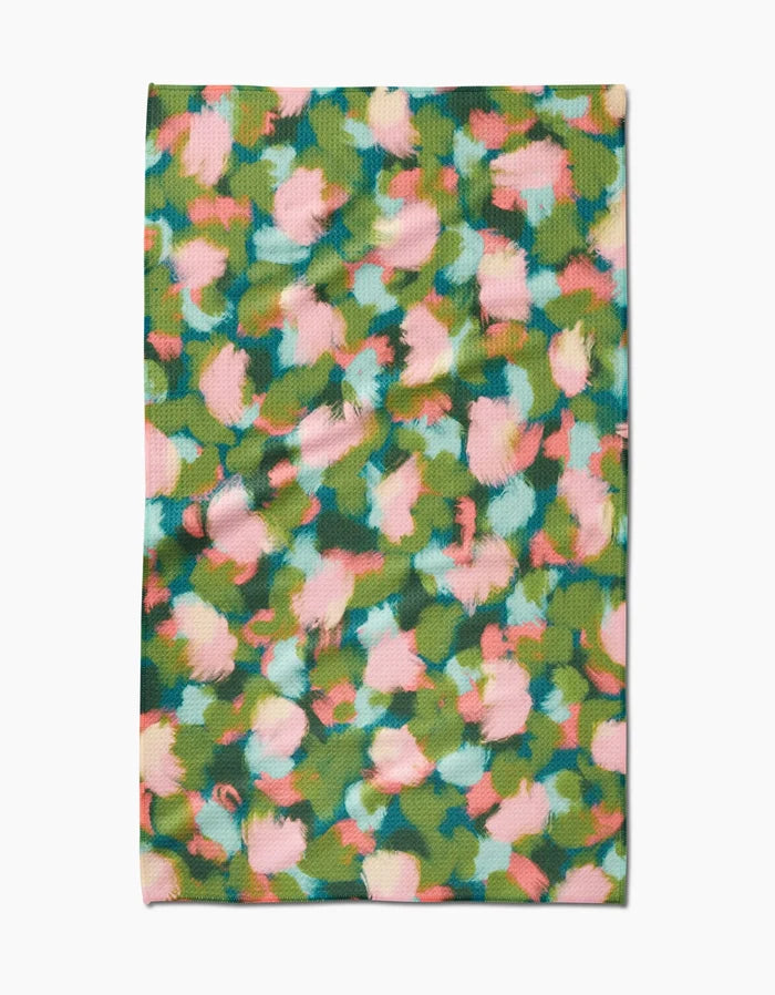Stroke of Genius by Shelley Smith is a rectangular Geoweave fabric with an abstract floral pattern in green, pink, blue, and yellow, shown flat on a white background.