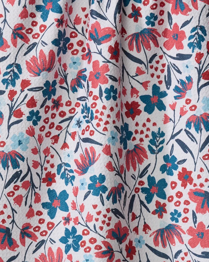 Summer Bloom by Hufton Studio features a colorful floral pattern with red, blue, and navy flowers plus green leaves on white. The slightly wrinkled, textured fabric is perfect for an eco-friendly kitchen towel made from recycled materials.