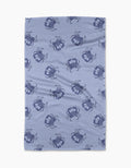 The Geometry Summer Crabs Tea Towel features dark blue crabs on a light blue, subtly dotted background. Made from eco-friendly material, it has a slightly wrinkled look and is shown on a white surface.