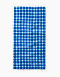 The Danelys Sidron Summer Plaid bar towel, crafted from ultra-absorbent Geoweave fabric, showcases a blue and white checkered pattern and is displayed flat on a white background.
