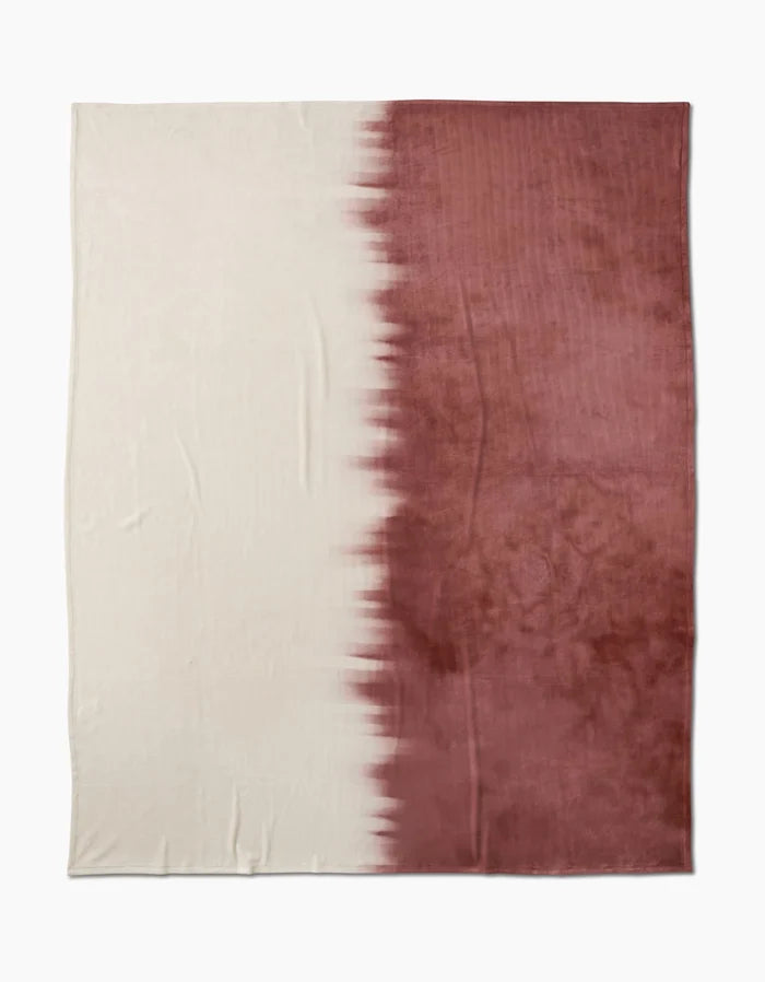 The Sundae by Geometry is a rectangular, eco-friendly blanket made from recycled materials. It features a two-tone design: off-white on the left and deep reddish-brown on the right, with a jagged blended transition between the colors.