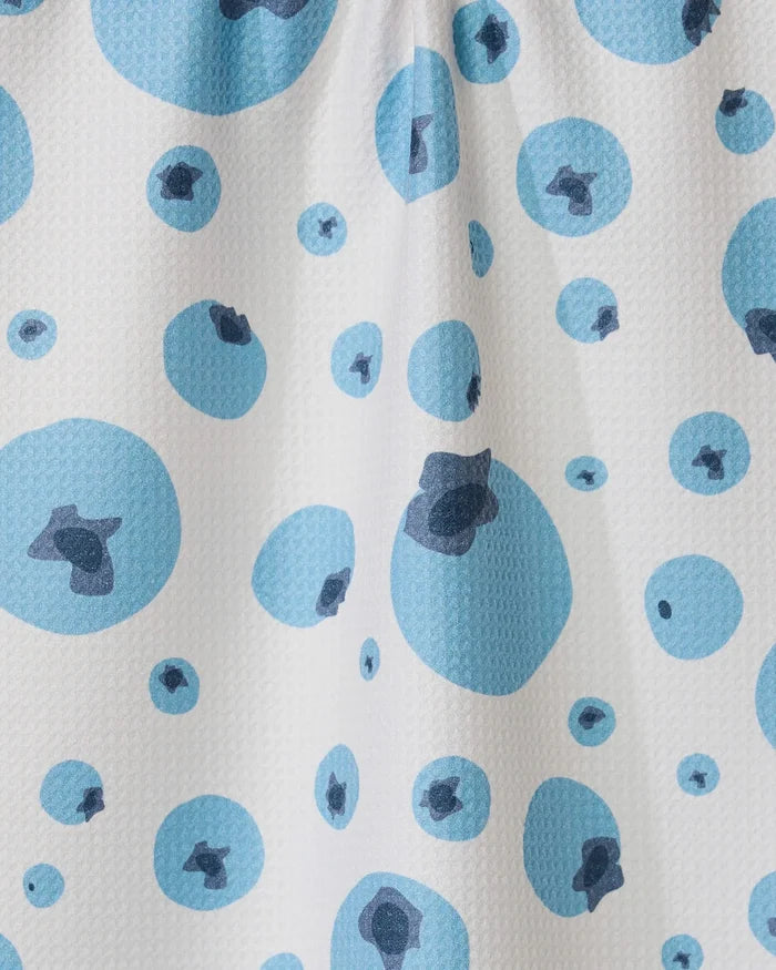 The GEOMETRY Sunny Blueberries tea towel features white Geoweave fabric with a textured surface and a scattered pattern of blue circles, each with a darker blue center, combining stylish design with functionality.