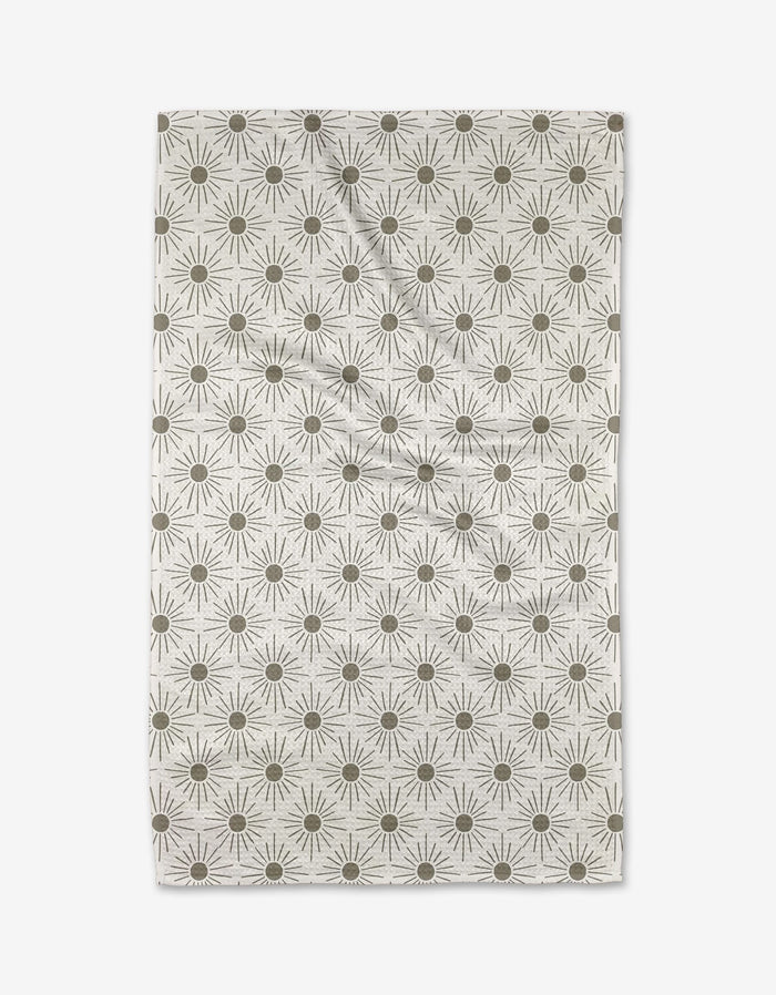 The Hufton Studio Sunny Geo is a rectangular beige cloth featuring evenly spaced olive green sunbursts. Made from ultra-absorbent Geoweave fabric, it has a slightly wrinkled appearance.