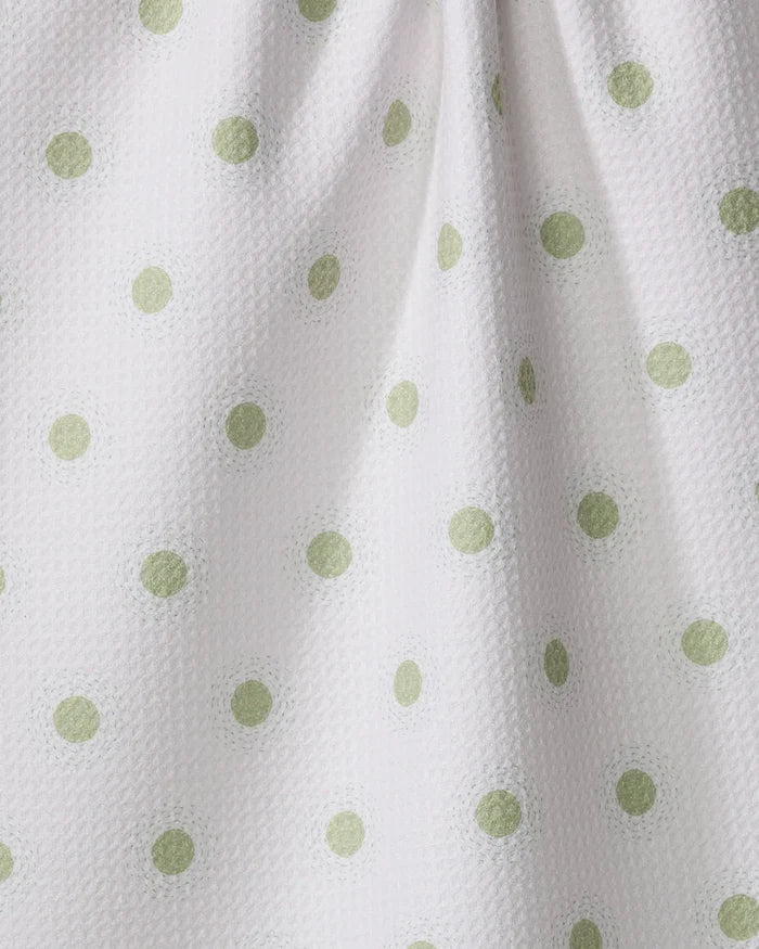 Close-up of Sunshine Glow by Danelys Sidron—a white, eco-friendly tea towel with light green polka dots and a softly dimpled texture, ideal as an absorbent kitchen dish towel.