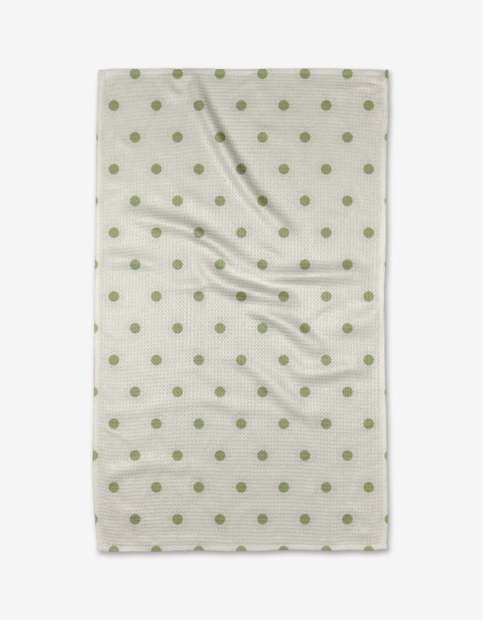 The Danelys Sidron Sunshine Glow is a rectangular white tea towel with evenly spaced green polka dots, shown flat with slight wrinkles.