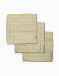 Three Sunspread kitchen towels from GEOMETRY, featuring a yellow and white checkered Geoweave fabric, are partially overlapping each other on a white background.