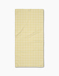 The GEOMETRY Sunspread Bar Towel, featuring a rectangular yellow and white checkered design in Geoweave fabric, is laid flat on a white background.