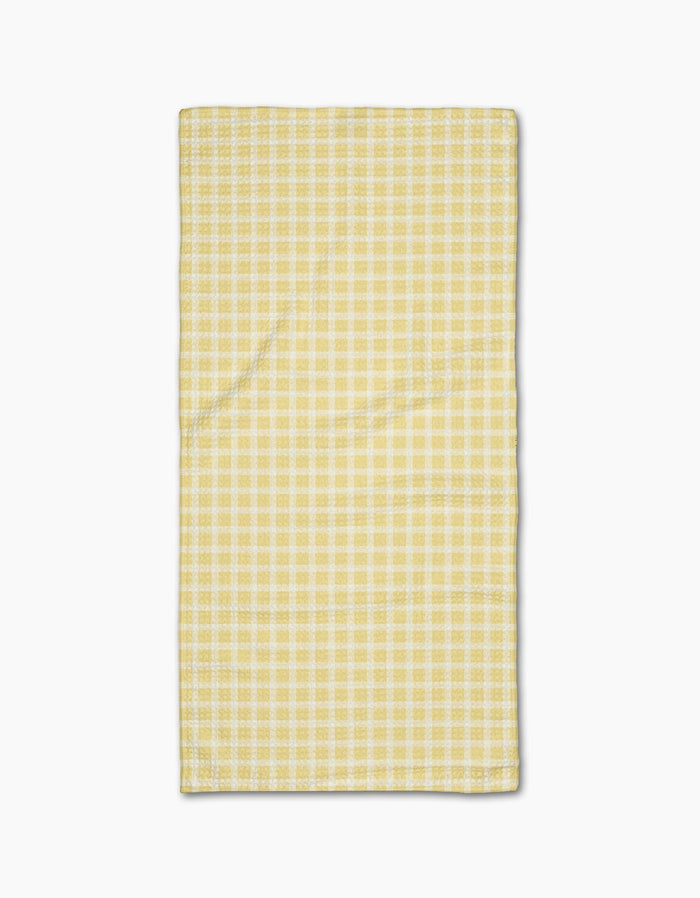 The GEOMETRY Sunspread Bar Towel, featuring a rectangular yellow and white checkered design in Geoweave fabric, is laid flat on a white background.