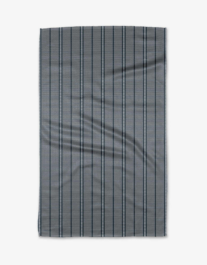 A rectangular navy Super Stripe tea towel by The Buy Guide features bold dark stripes. Made from Geoweave fabric, it has slight wrinkles and is laid flat on a white background.