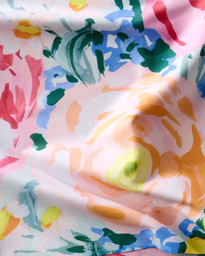 Suzzy Dinner Napkin Set by Ania Zwara Art features eco-friendly fabric with a watercolor floral pattern in pink, yellow, blue, and green abstract blooms—an elegant touch for any table.