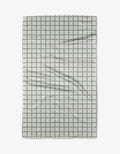 The Kailee Wright Sweet Mint towel is a white Geoweave cloth with a green grid pattern, showing a few visible folds and wrinkles.