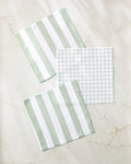 The Kailee Wright Sweet Mint dishcloth set includes two with bold green and white stripes and one in a fine green grid on white. These absorbent, stylish cloths add a fresh touch to your kitchen.