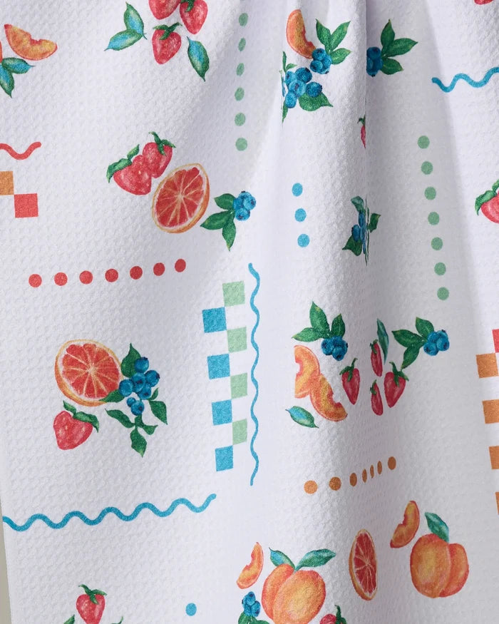 Sweet Pickings by Aubrey Fairchild is a white textured tea towel featuring colorful fruit illustrations and decorative red, green, blue, and orange patterns. Made from ultra-absorbent materials for style and function.