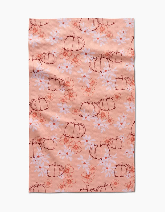 The Sweet Pumpkin Harvest by Ashley Celena is a peach recycled kitchen towel with hand-drawn pumpkins, white daisies, and orange floral accents. Ultra-absorbent with a charming, slightly wrinkled finish.